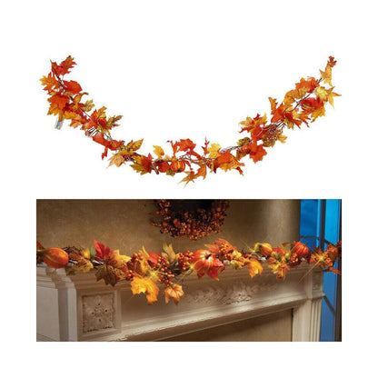 A 1.8m LED light-up autumn pumpkin and maple leaf vine garland glowing warmly draped across a wooden front door.