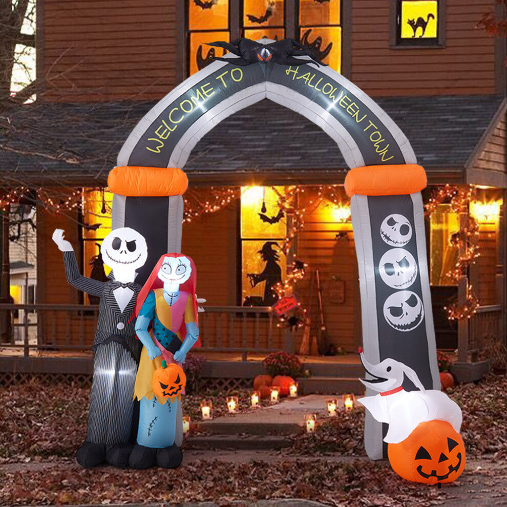 Front view of a 10ft tall inflatable Halloween archway with Jack Skellington and Sally illuminated by internal LEDs on a lawn.