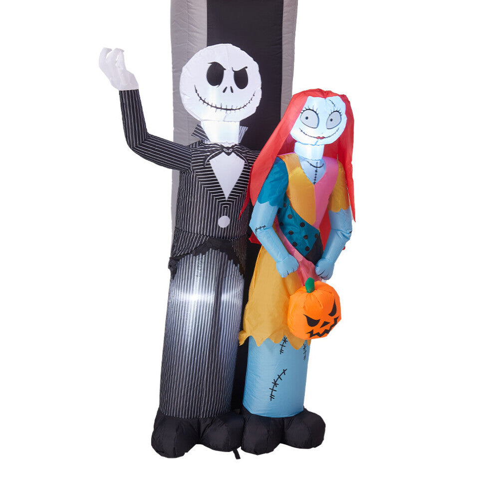 Front view of a 10ft tall inflatable Halloween archway with Jack Skellington and Sally illuminated by internal LEDs on a lawn.