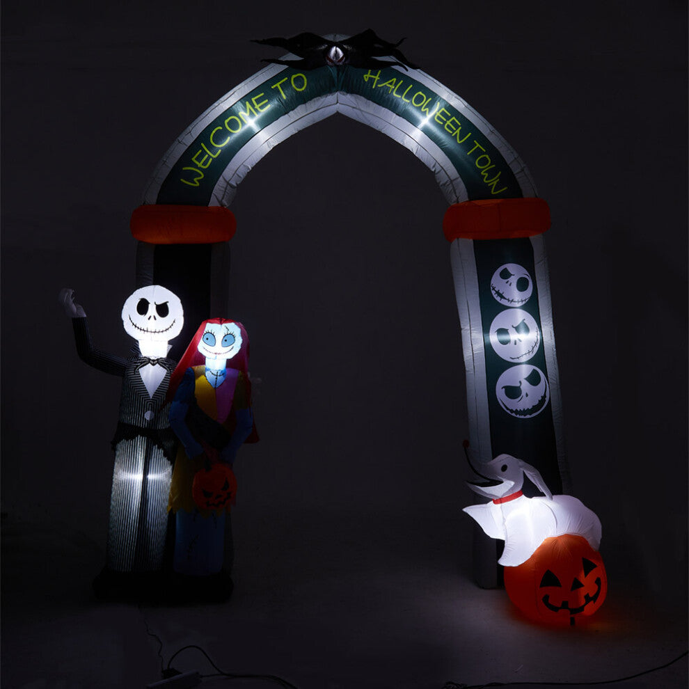 Front view of a 10ft tall inflatable Halloween archway with Jack Skellington and Sally illuminated by internal LEDs on a lawn.