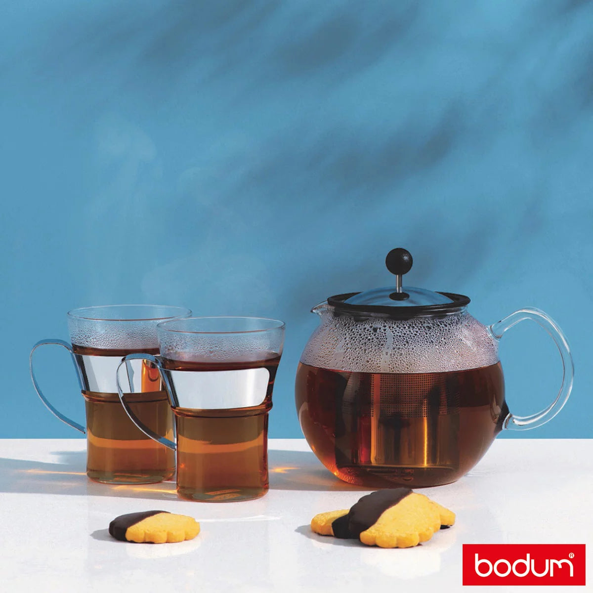 Bodum Assam 1L tea press with borosilicate glass carafe, stainless steel filter, and 2 included matching tea glasses on white background
