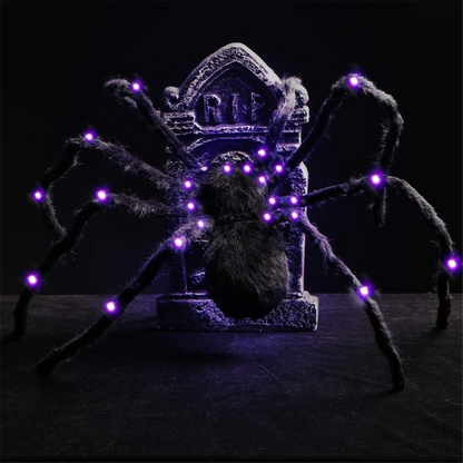 A 2.9ft large hairy black spider with glowing LED eyes clinging to a spooky web outdoors during Halloween night.