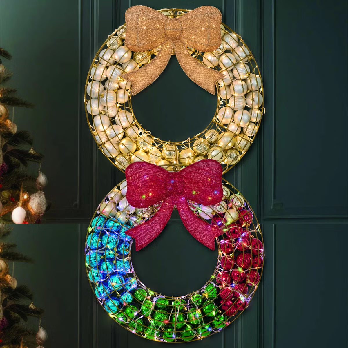 Frontal view of a 24-inch red indoor holiday wreath made of glossy and matte ornaments glowing with warm white LED lights over a dark brick mantelpiece.