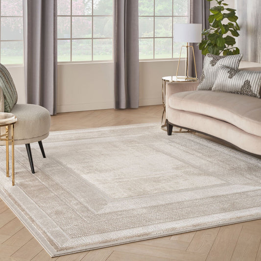 Nourison Glitz ivory border area rug, low pile polyester with shimmer finish
