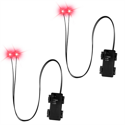 A pair of glowing red LED skeleton eyes mounted inside a dark Halloween prop skull outdoors at night.