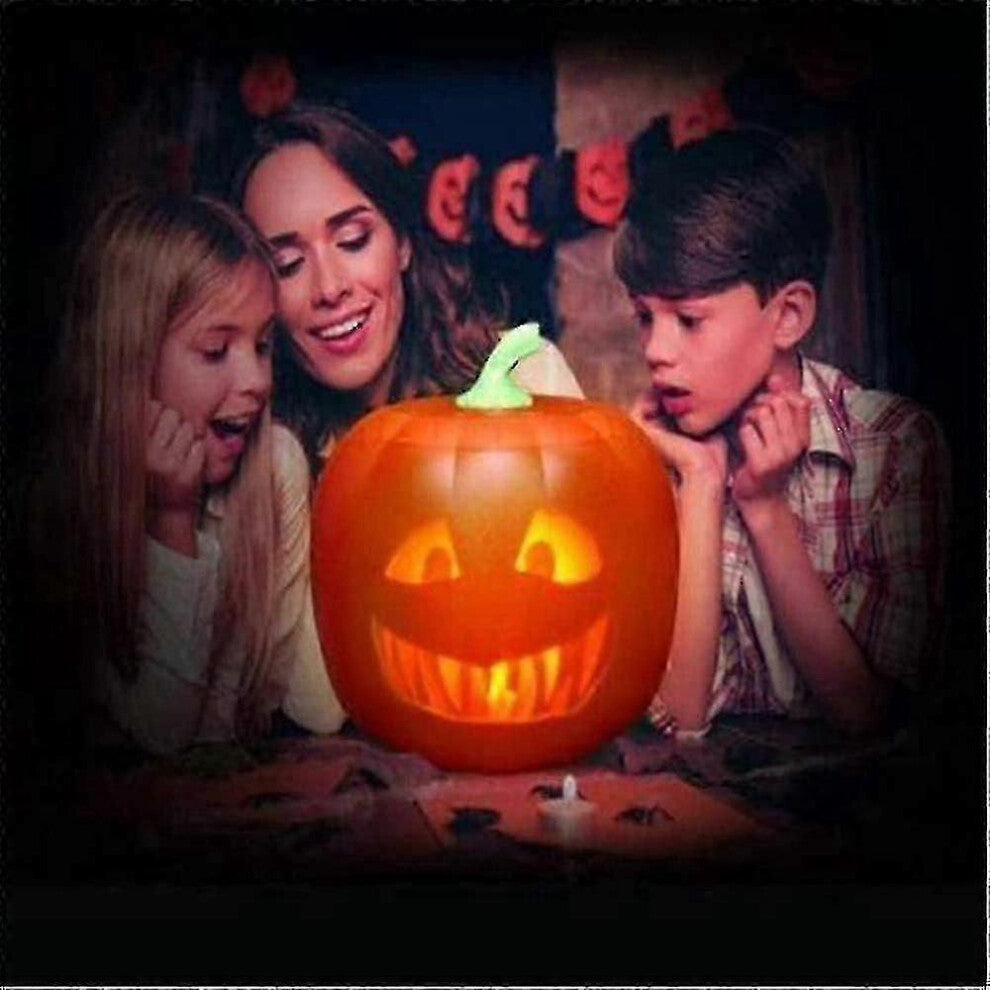 An animated 3-in-1 LED talking pumpkin projection lamp displaying vibrant seasonal graphics on a festive party table.