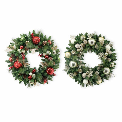 Front view of a 30-inch pre-lit holiday wreath with dense green faux pine needles, natural pinecones, red ornaments, and 50 glowing warm white LEDs displayed on a dark wooden front door.