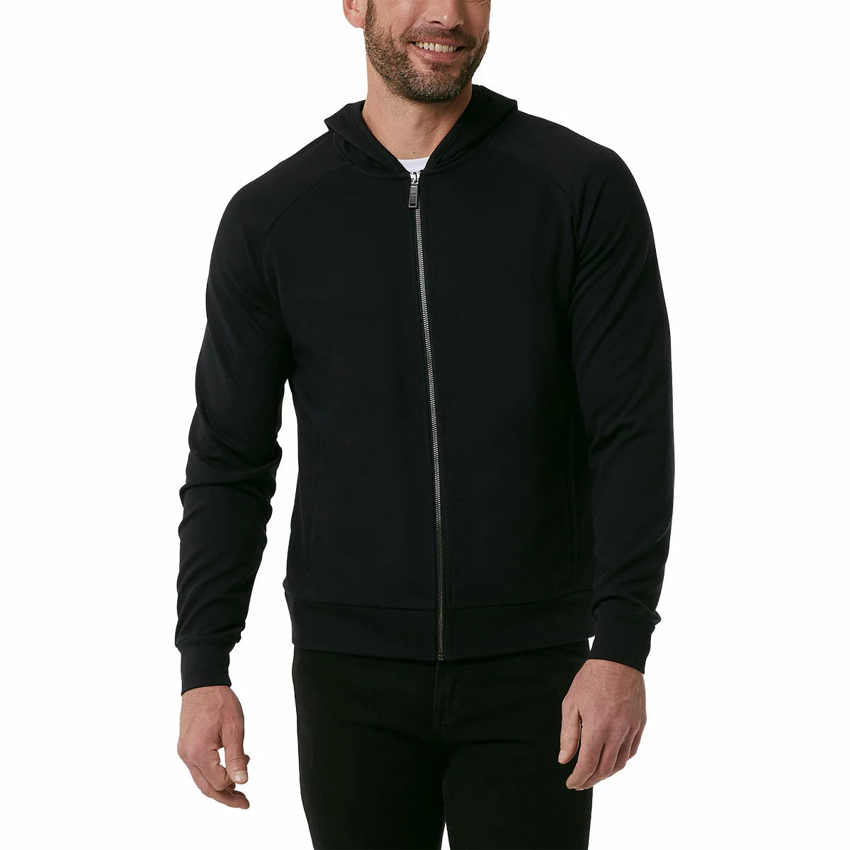 Front view of a man wearing the textured 32 Degrees Pique Full Zip Hoodie featuring zippered hand pockets in a modern casual setting