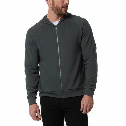 Front view of a man wearing the textured 32 Degrees Pique Full Zip Hoodie featuring zippered hand pockets in a modern casual setting