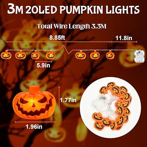 A 3M string of 20 3D pumpkin LED lights glowing with a warm orange light across a decorated indoor window.