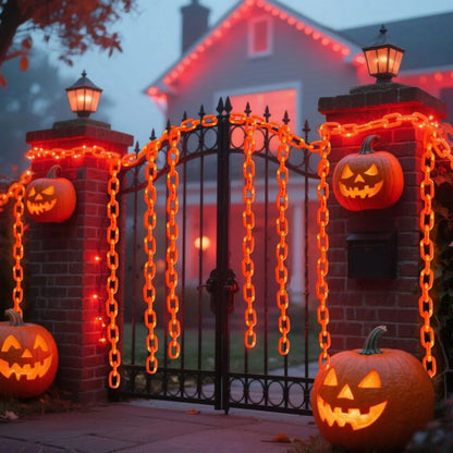 A 3m string of Halloween plastic chain lights glowing with vibrant orange LEDs, draped across a spooky outdoor skeleton dog prop at night