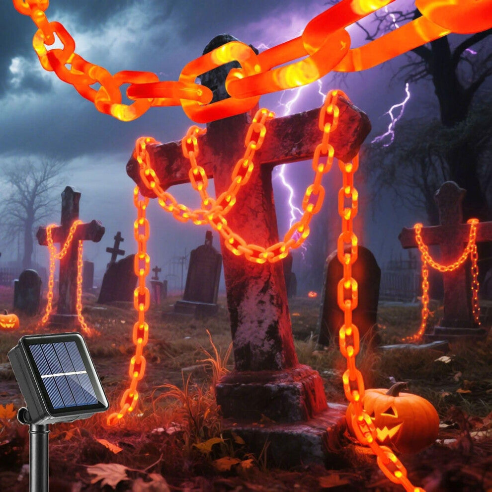 A 3m string of Halloween plastic chain lights glowing with vibrant orange LEDs, draped across a spooky outdoor skeleton dog prop at night