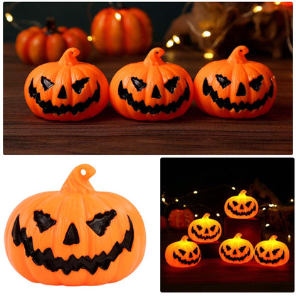 A set of three durable plastic Halloween LED light-up pumpkin lanterns featuring terror face designs glowing softly on a festive party table.