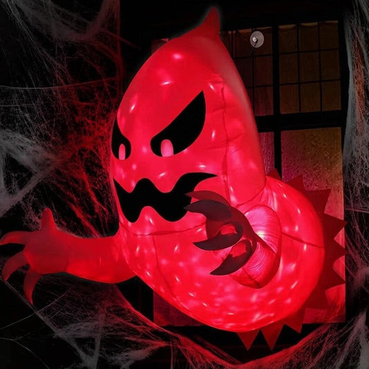 Exterior nighttime shot of a 4.6ft illuminated inflatable white ghost with glowing red LED flame effects appearing to break out of a dark house window.