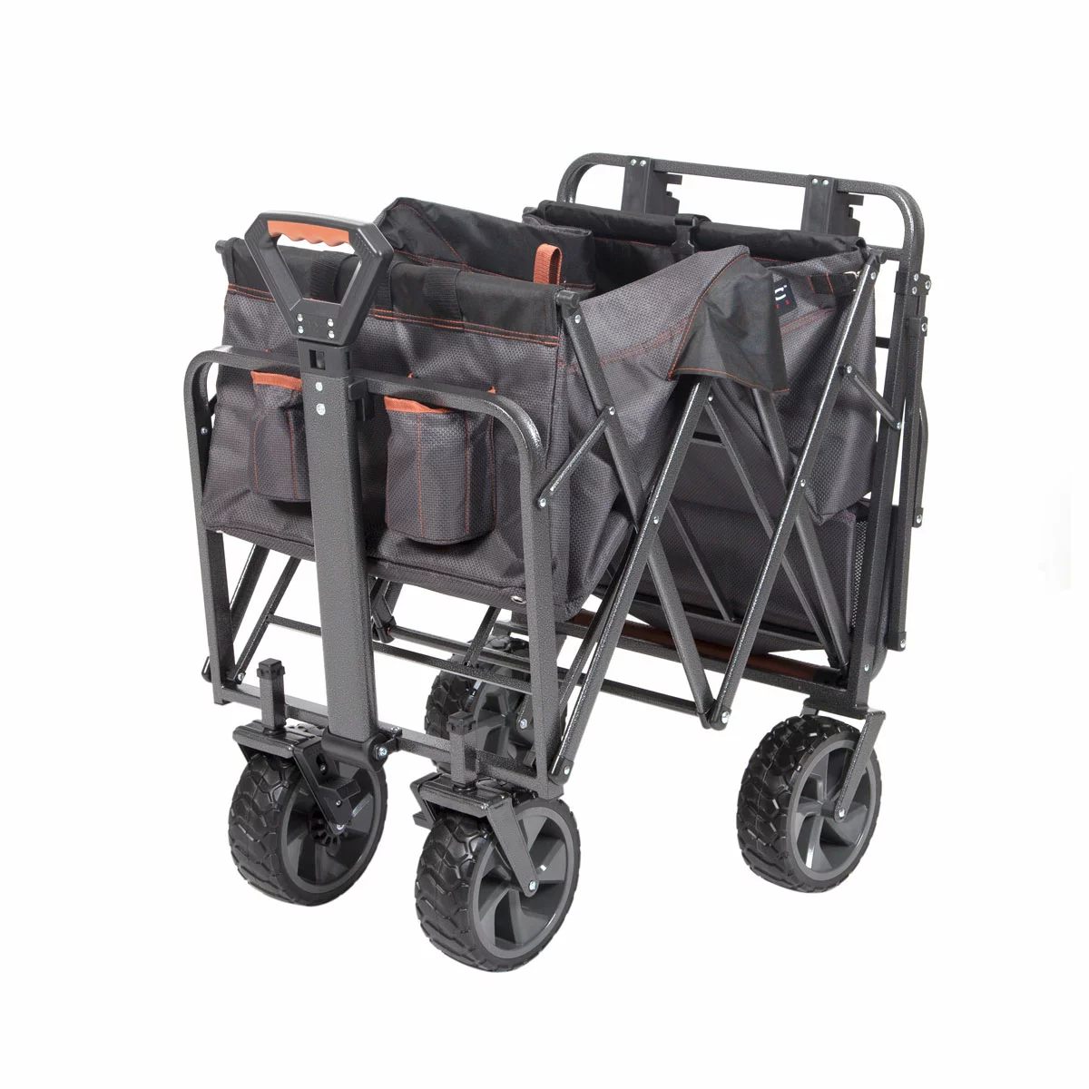 A heavy-duty black Mac Sports Deluxe Folding Wagon stands on a grassy field, highlighting its wide all-terrain wheels, integrated front brakes, and extended telescoping handle.
