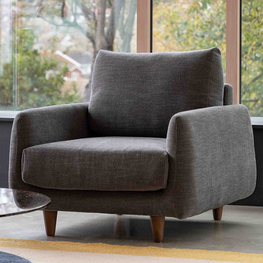 Gallery Oakwood fabric armchair in dark grey with solid oak legs
