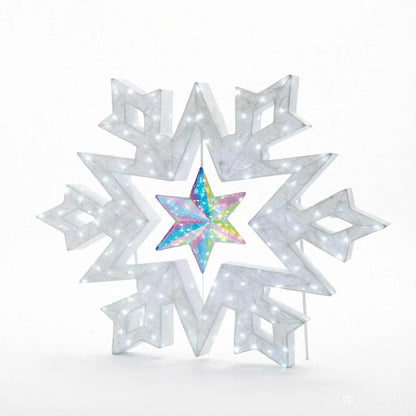 A 48-inch illuminated white LED snowflake holiday light with a center rotating prismatic star glowing brightly on a dark green outdoor lawn at night.