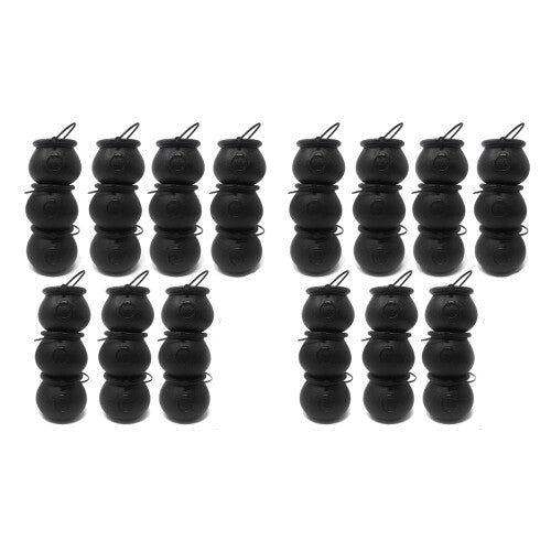 A group of mini black plastic witch candy cauldrons with curved handles arranged on a table filled with Halloween treats.