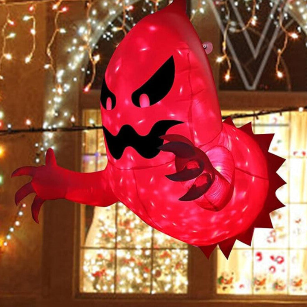 Side view of a 4ft white inflatable Halloween ghost with bright internal LED lights attached to a house window pane with suction cups.