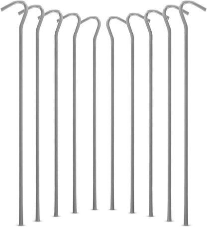 A bundle of fifty silver galvanised steel J-hook tent pegs arranged neatly on a patch of short green grass next to a set up camping tent.