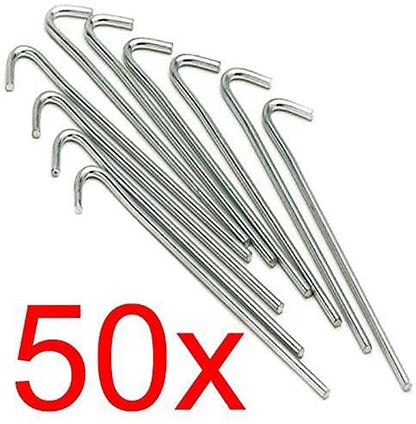 A bundle of fifty silver galvanised steel J-hook tent pegs arranged neatly on a patch of short green grass next to a set up camping tent.