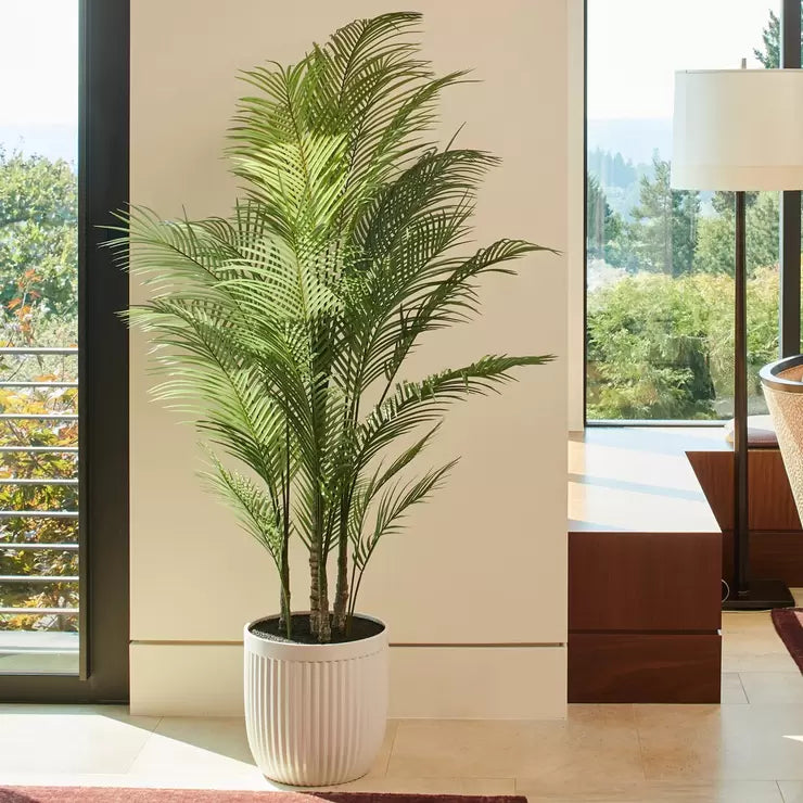 A 6.5ft tall artificial palm tree with vibrant green fronds, displayed in a sophisticated modern ribbed planter.