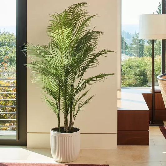 A 6.5ft tall artificial palm tree with vibrant green fronds, displayed in a sophisticated modern ribbed planter.