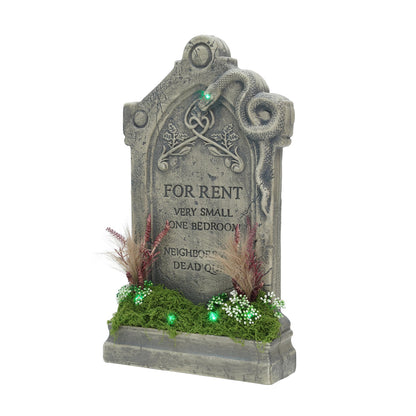 Front view of a 60cm Samuel Alexander grey weathered tombstone prop featuring a green LED glow, sculpted snake, artificial moss base, and 'For Rent' inscription.
