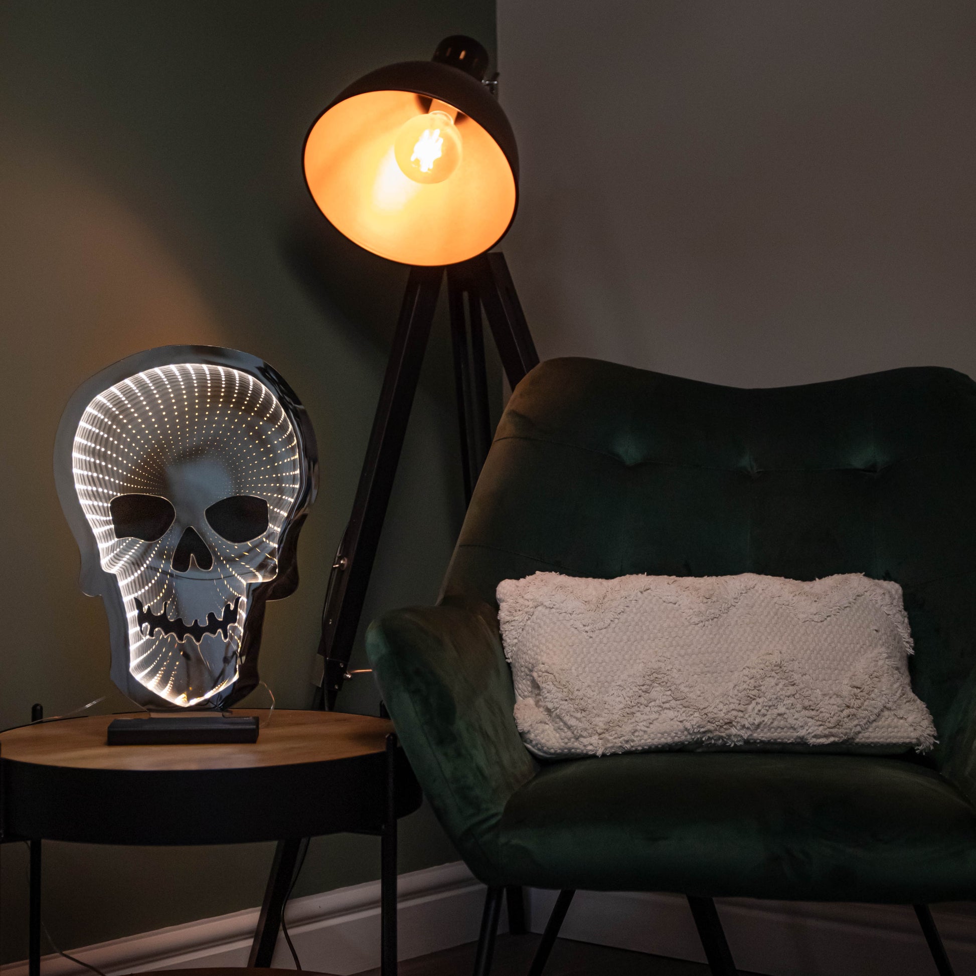 Samuel Alexander 60cm light up Halloween skull infinity light with warm white LEDs glowing on a wooden base in a darkened room setting.