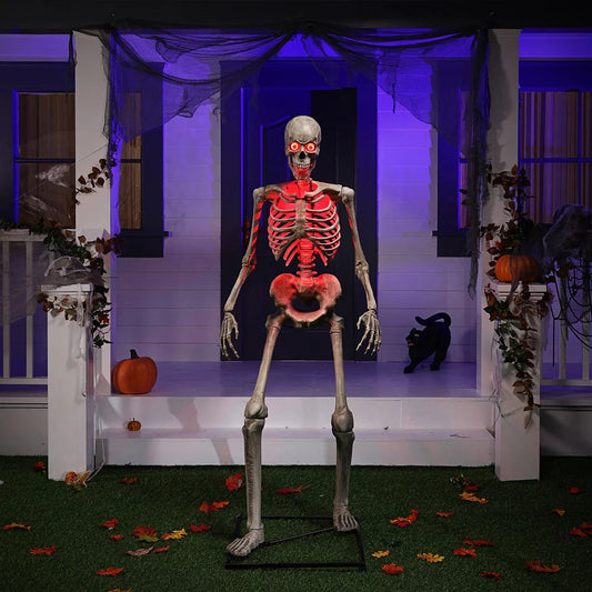 A 6ft animatronic Halloween skeleton with glowing red LED eyes and shifting RGB chest light positioned on a misty lawn at night.