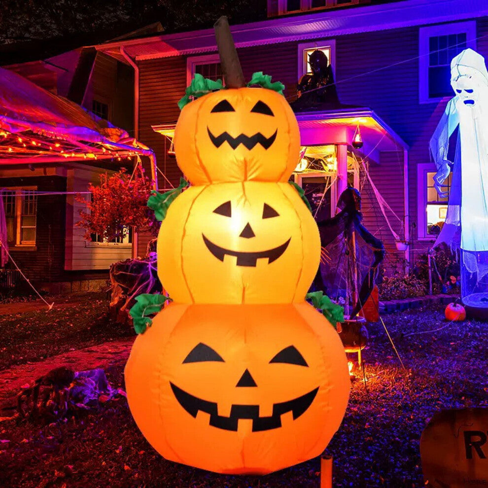 Front view of a 6-foot-tall orange inflatable Halloween pumpkin with glowing internal LEDs and a ghostly companion on a green garden lawn at night.