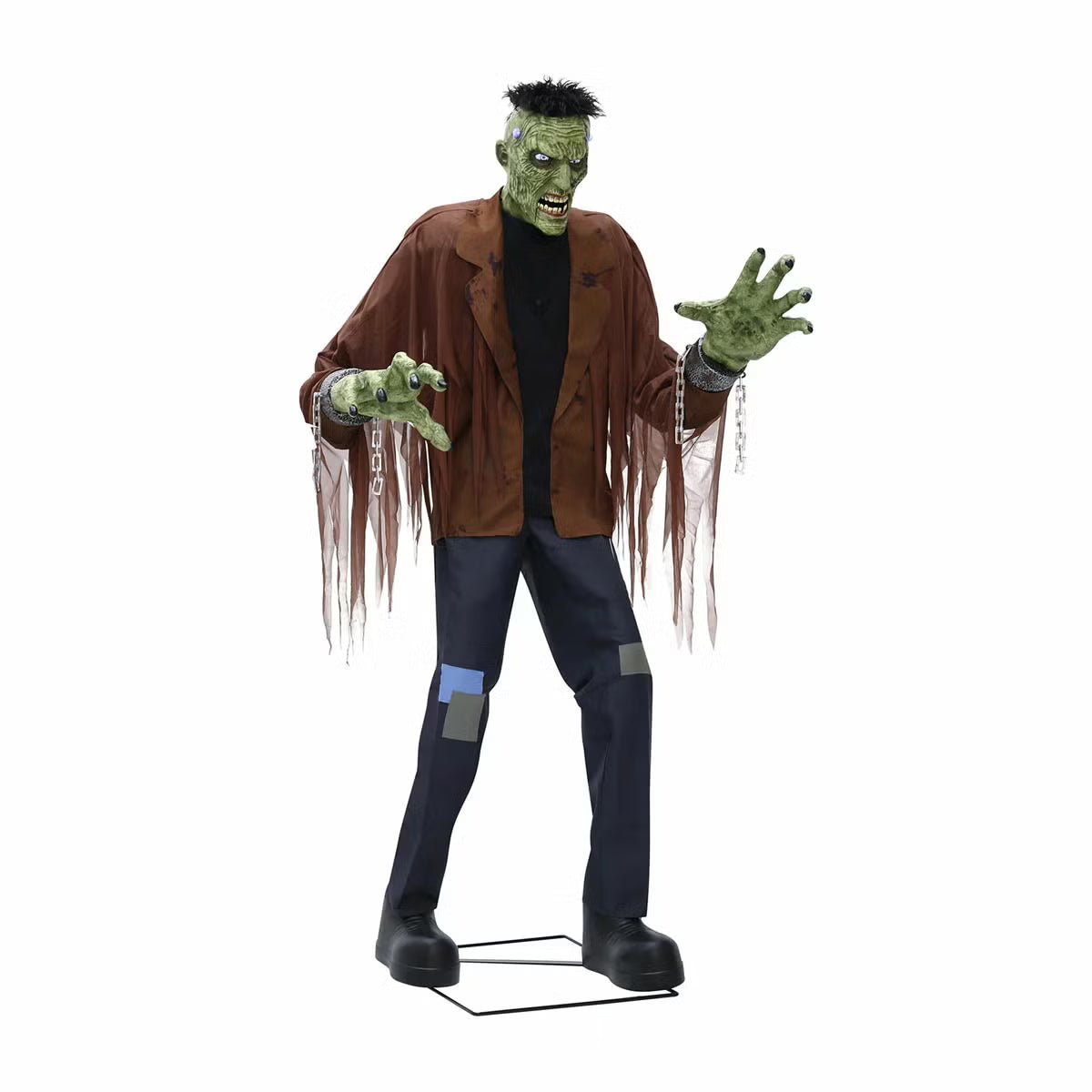 Front view of a 7.5ft tall animated Frankenstein monster prop with glowing blue LCD eyes, rugged green skin, torn jacket, and flickering head electrodes standing outdoors.