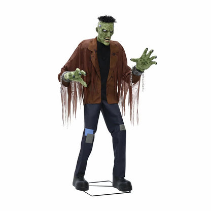 Front view of a 7.5ft tall animated Frankenstein monster prop with glowing blue LCD eyes, rugged green skin, torn jacket, and flickering head electrodes standing outdoors.