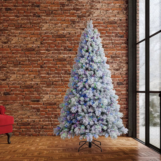 A tall 7.5ft pre-lit glitter flocked cashmere artificial Christmas tree illuminated by warm micro twinkle LED lights in an elegant indoor living room setting.
