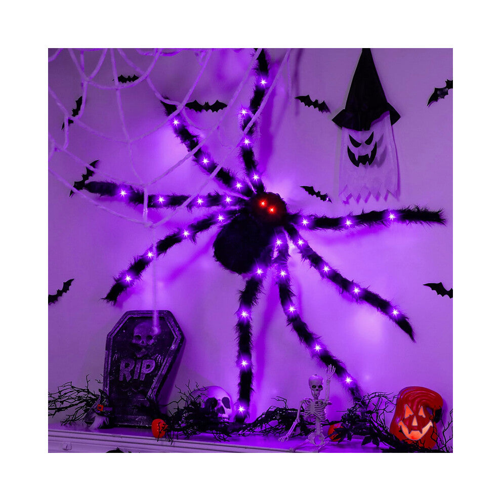A 90cm black hairy Halloween spider decoration with glowing LED lights on its eyes and legs, positioned on a spooky web backdrop.
