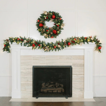 Close-up of a 9ft pre-lit artificial Christmas garland featuring 90 warm white glowing LED lights, realistic pine branches, pinecones, and red festive ornaments draped indoors.