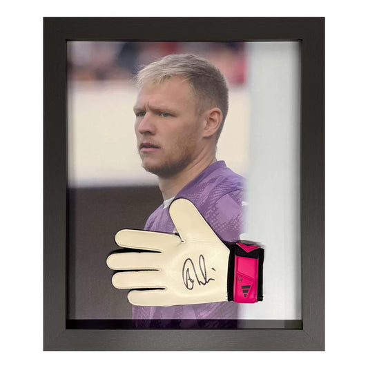 A professional, wall-mounted display case featuring an authentic Adidas goalkeeper glove signed by Aaron Ramsdale, set against a clean, neutral backing.