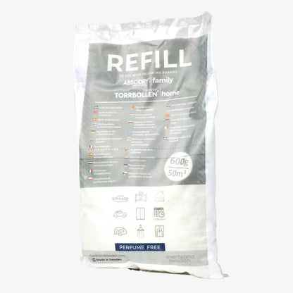 Front view of the minimalist Scandinavian Absodry Moisture Absorber unit next to a 600g refill pack and hanging textile wardrobe bag on a clean shelf.