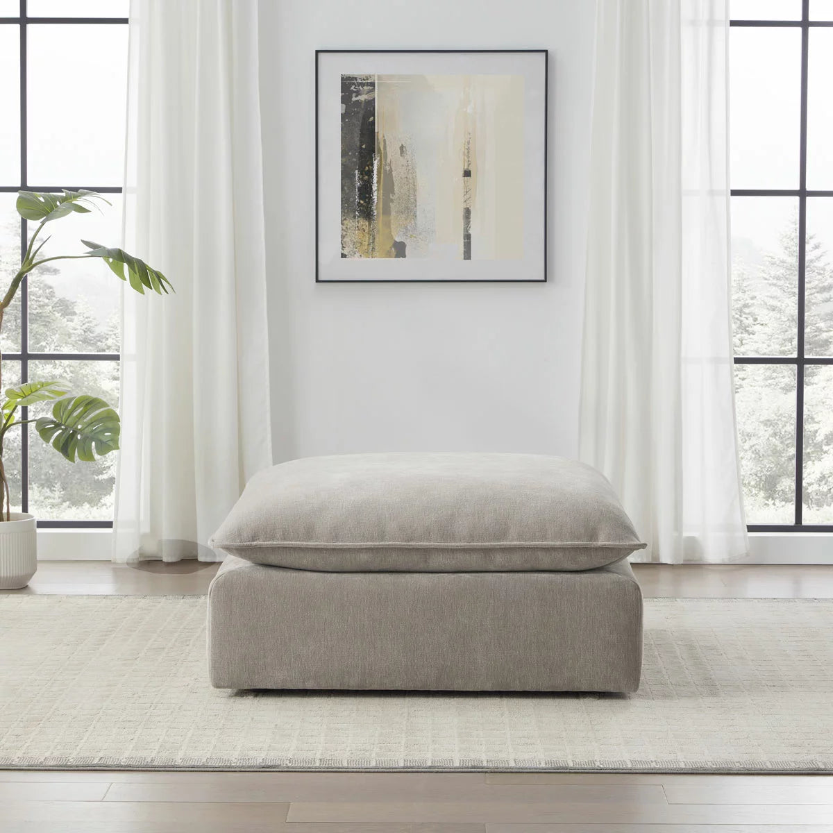 Aiden & Ivy Sereen Beige Fabric Ottoman upholstered in soft beige fabric for stylish seating and footrest use in modern living rooms.