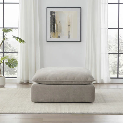 Aiden & Ivy Sereen Beige Fabric Ottoman upholstered in soft beige fabric for stylish seating and footrest use in modern living rooms.