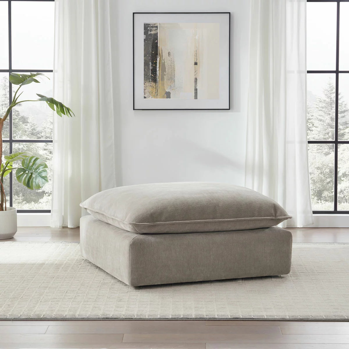 Aiden & Ivy Sereen Beige Fabric Ottoman upholstered in soft beige fabric for stylish seating and footrest use in modern living rooms.