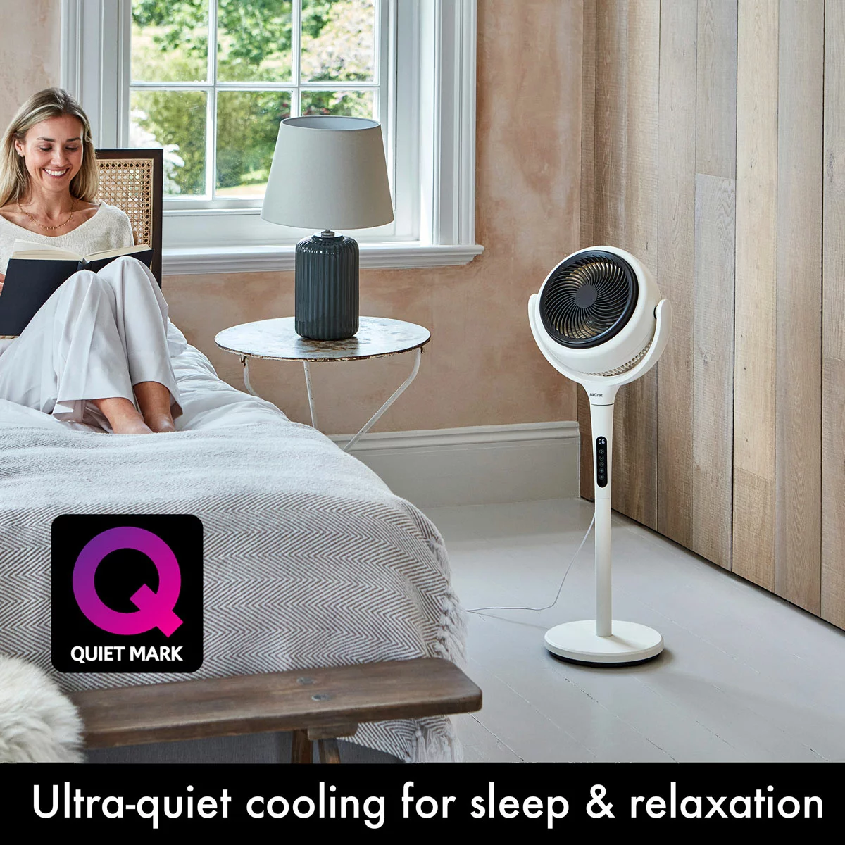 Convertible stone white AirCraft LUME 2-in-1 air circulator fan with illuminated rear backlight standing on a wooden floor beside a lounge sofa.
