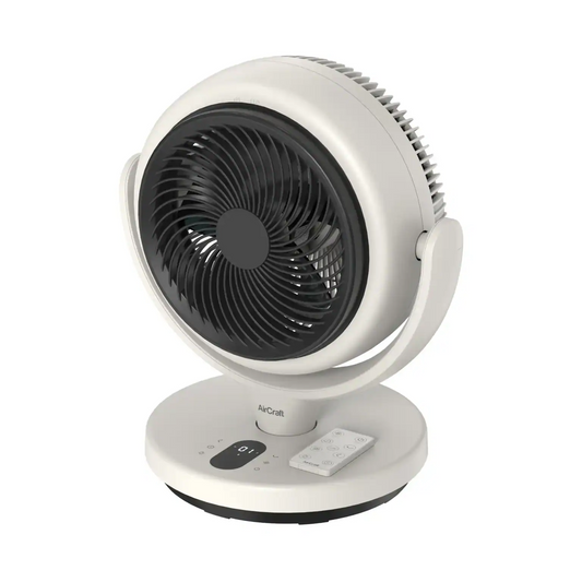 AirCraft LUME MINI white table air circulator fan with magnetic remote control on a modern bedside table.