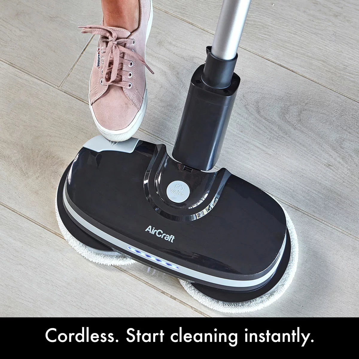 AirCraft PowerGlide cordless hard floor cleaner and polisher in black with extra cleaning pads for sealed floors.