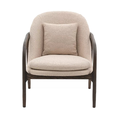 A front-three-quarter view of the Gallery Alegra taupe fabric armchair, showing its curved dark wood frame and comfortable padded taupe cushions in a sunlit room.