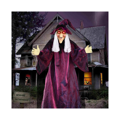 Hanging life-size Halloween animatronic witch in black yellow robes with glowing red LED eyes and grey hair.
