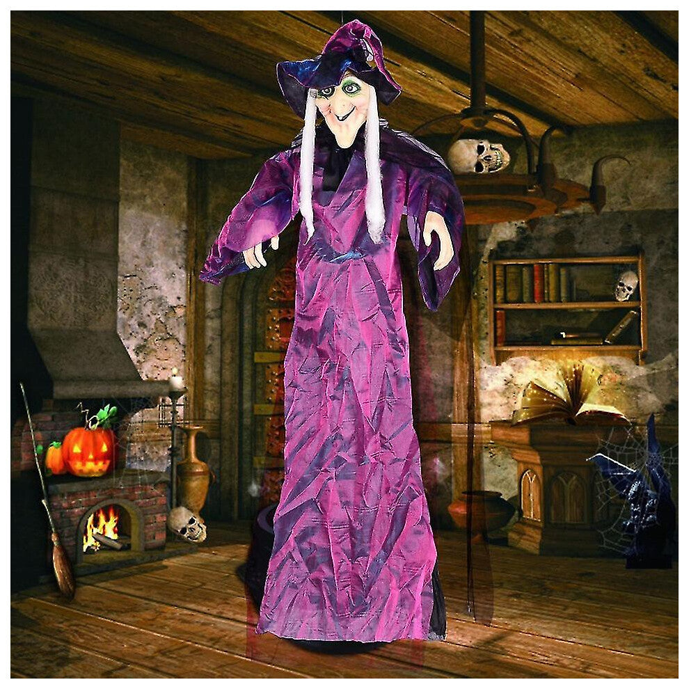 Hanging life-size Halloween animatronic witch in black yellow robes with glowing red LED eyes and grey hair.