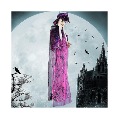 Hanging life-size Halloween animatronic witch in black yellow robes with glowing red LED eyes and grey hair.