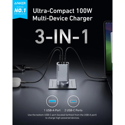 Black Anker Prime 100W GaN wall charger plugged into an outlet with two braided black USB-C cables connected to a laptop and smartphone.