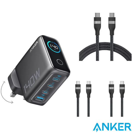 Front angle shot of the matte black Anker Prime 140W GaN charger with its vibrant colour display lit up, flanked by three neatly coiled grey braided USB-C cables on a modern wooden office desk.